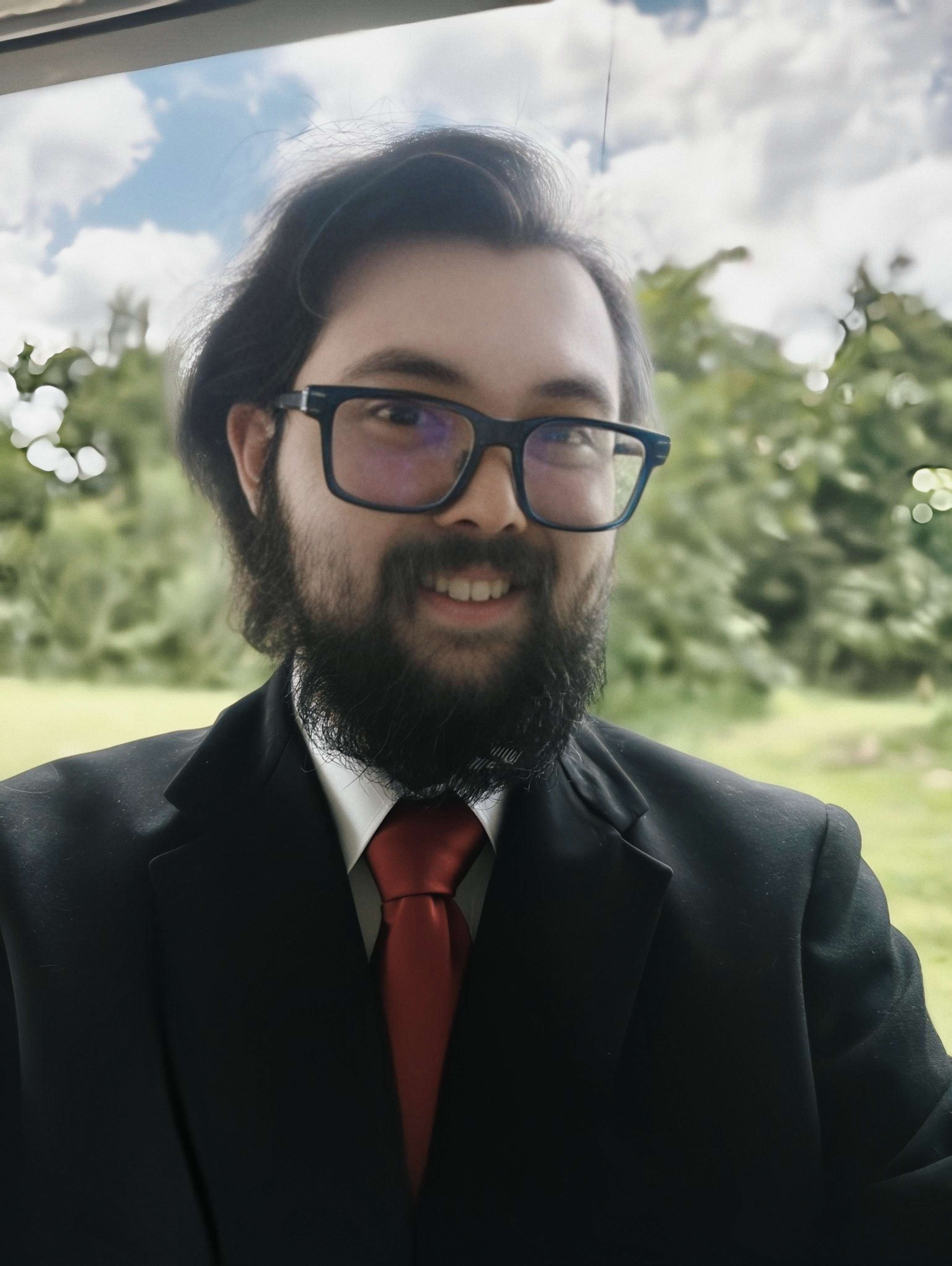 Photo of Dhontay wearing a black suit.